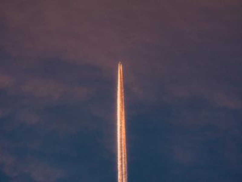 Rocket leaving cloud of smoke as it leaves Earth's atmosphere